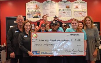 Chicken Salad Chick employees with big check