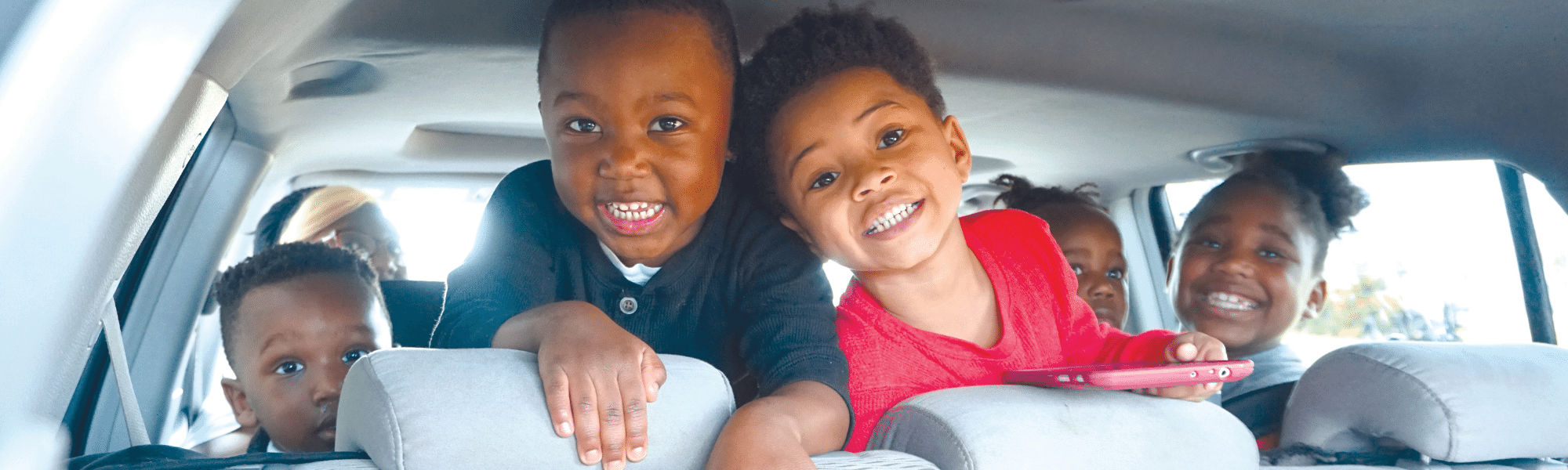 Children smiling at a christmas toy giveaway by united way of southwest louisiana following a hurricane